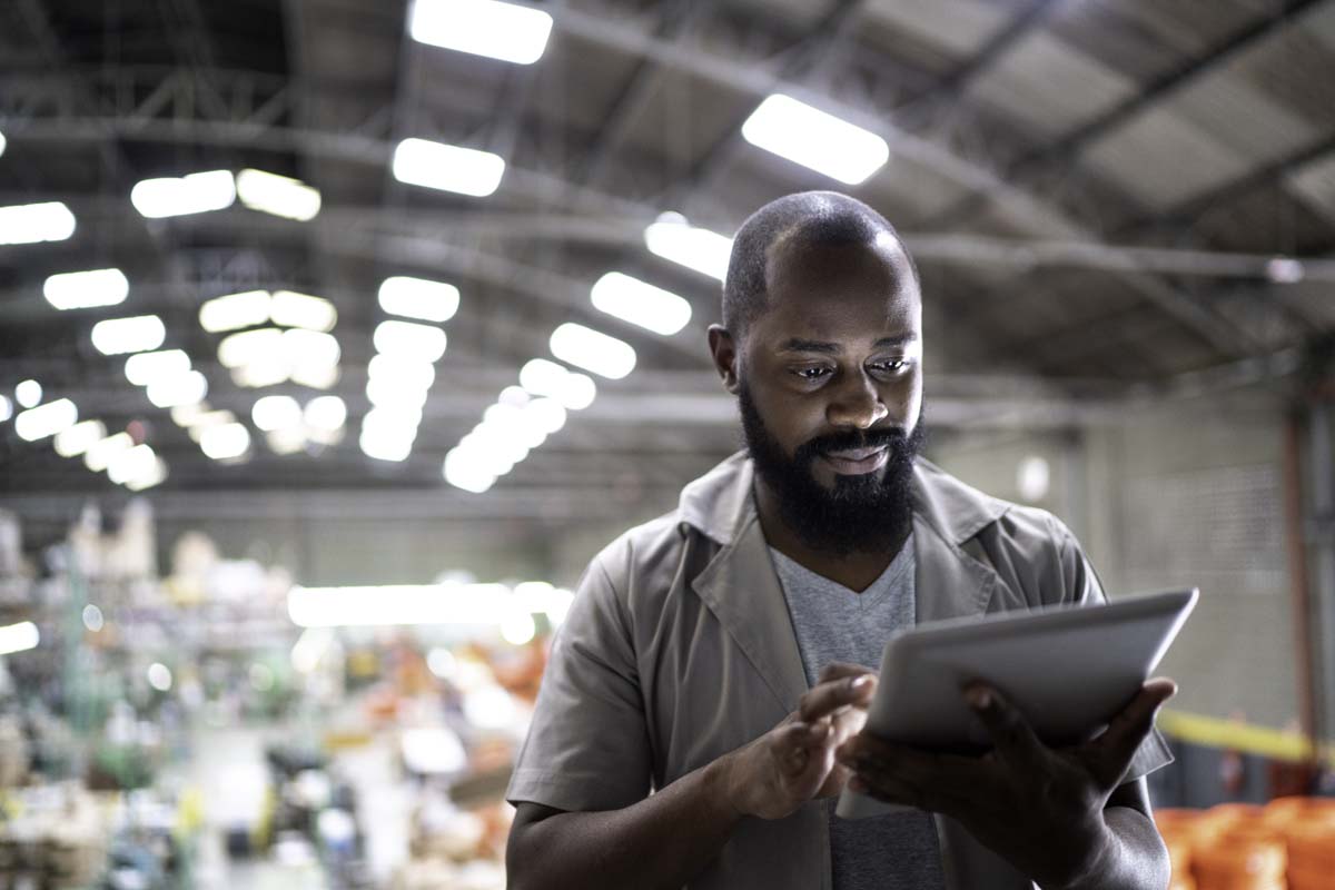 Warehouse professional reviewing operations on a tablet